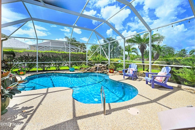 view of swimming pool with a patio and a lanai