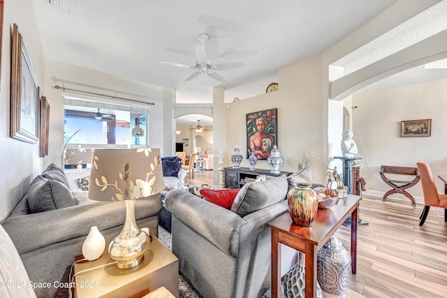 living room with ceiling fan and light hardwood / wood-style floors