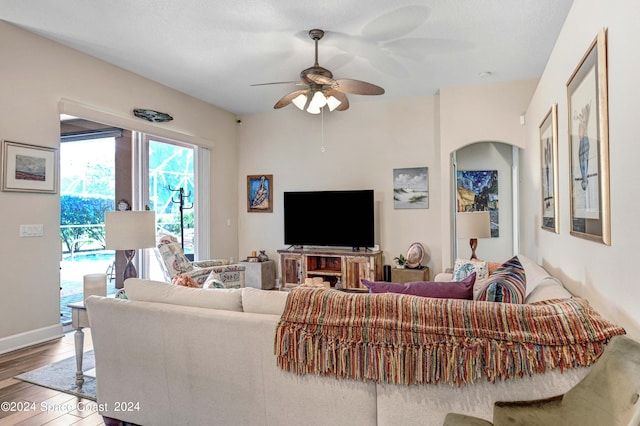 living room featuring hardwood / wood-style flooring and ceiling fan