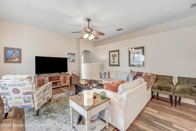 living room with ceiling fan and wood-type flooring