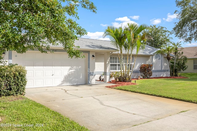 ranch-style house featuring a front lawn and a garage