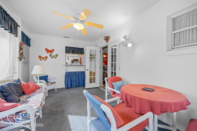 carpeted living room featuring ceiling fan and french doors