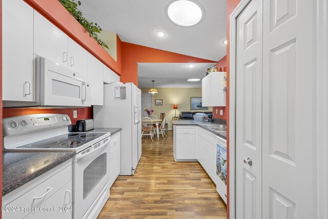 kitchen featuring white appliances, lofted ceiling, light hardwood / wood-style floors, and white cabinetry