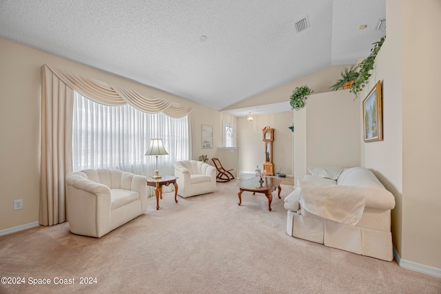 carpeted living room featuring vaulted ceiling and a textured ceiling