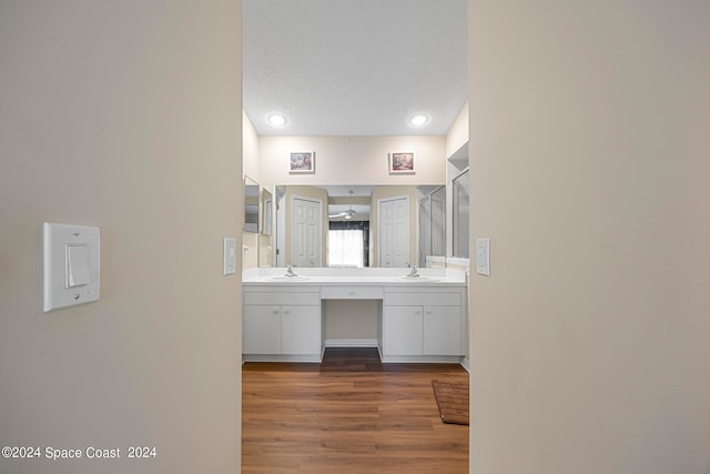 bathroom with wood-type flooring and double sink vanity