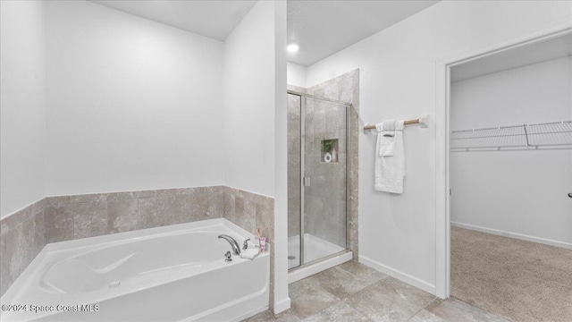 bathroom featuring shower with separate bathtub