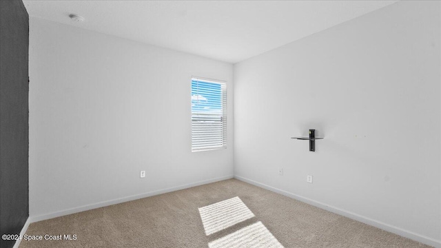 spare room with light carpet