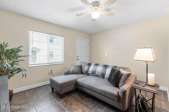 living room with dark tile patterned flooring and ceiling fan