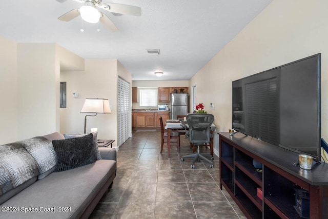 tiled living room with ceiling fan