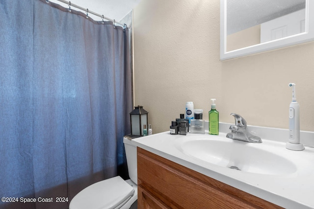 bathroom featuring toilet and vanity