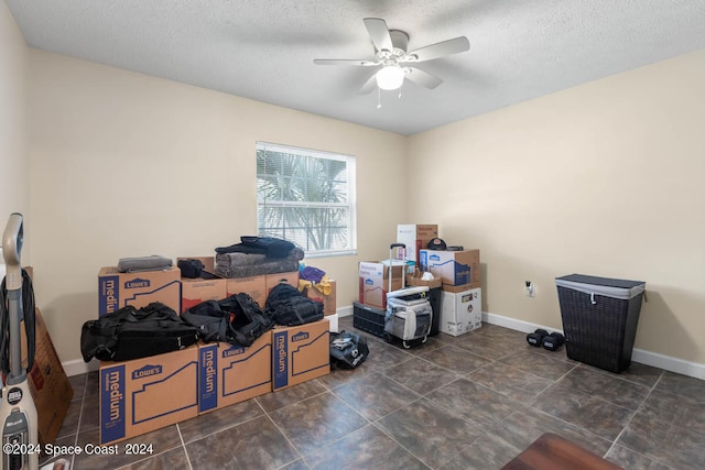 office with ceiling fan, a textured ceiling, and dark tile patterned floors