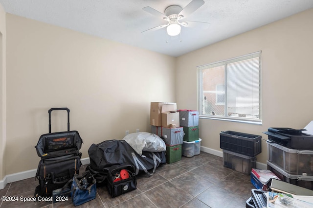 interior space with ceiling fan