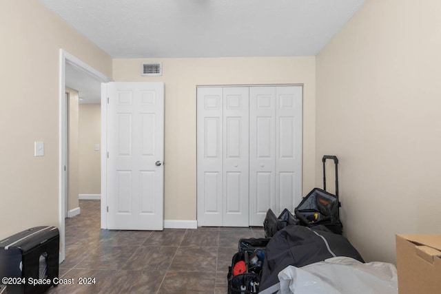 tiled bedroom with a closet