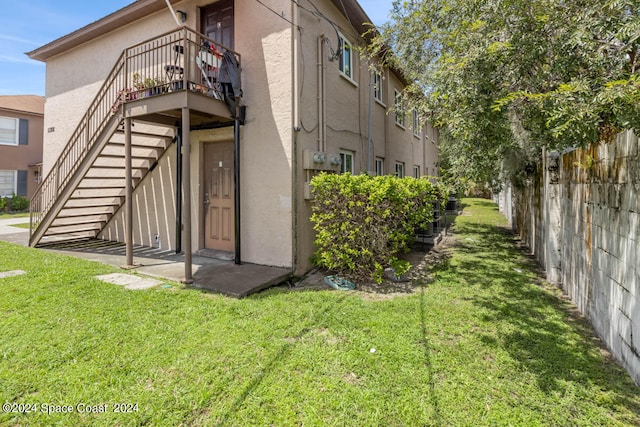 rear view of property featuring a yard