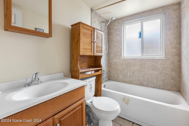 full bathroom with tile patterned flooring, tiled shower / bath, toilet, and vanity