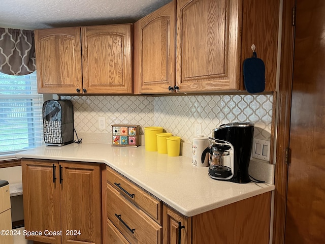 kitchen featuring decorative backsplash and a textured ceiling