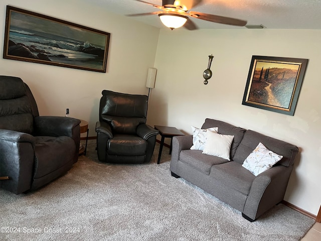 carpeted living room with ceiling fan