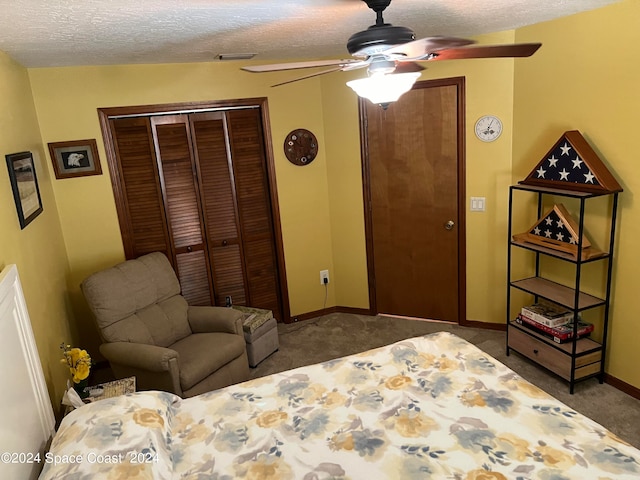 bedroom with dark colored carpet, ceiling fan, a textured ceiling, and a closet