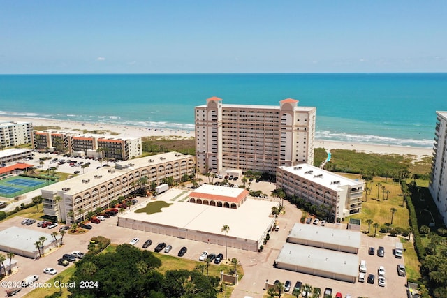 birds eye view of property with a water view, a view of the beach, and a city view