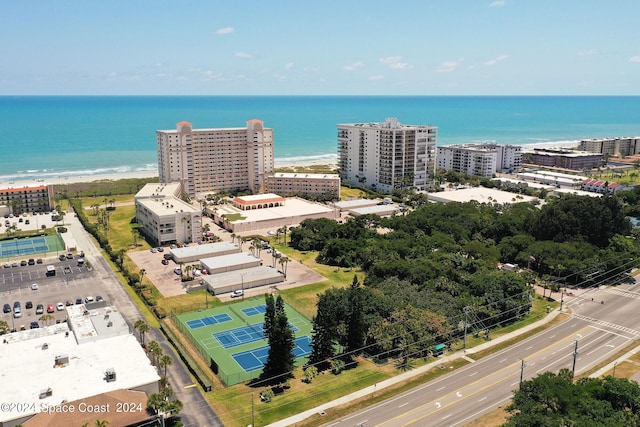 birds eye view of property featuring a water view and a city view