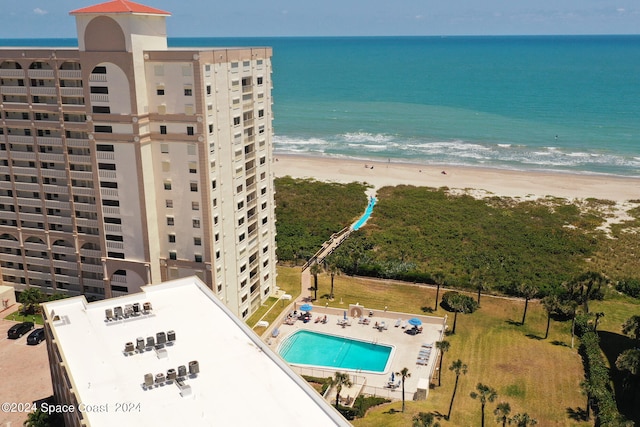 aerial view with a water view and a beach view