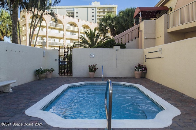 view of pool featuring fence private yard and a gate