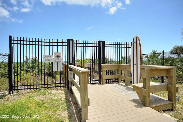 wooden terrace with fence and a gate