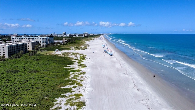 bird's eye view featuring a water view, a view of the beach, and a city view