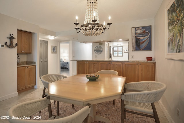 dining space with a notable chandelier and light tile patterned floors