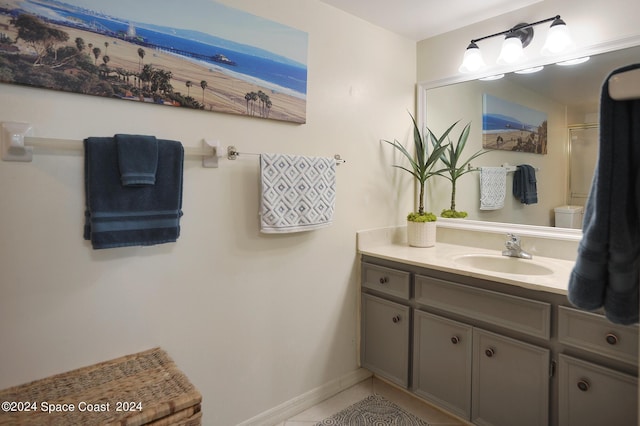 bathroom with tile patterned flooring, vanity, and baseboards