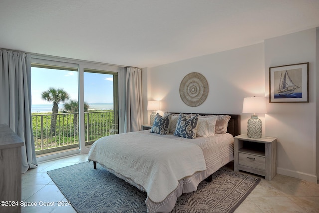 bedroom with access to outside, baseboards, and light tile patterned floors