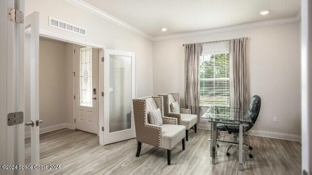 sitting room featuring french doors, hardwood / wood-style flooring, and crown molding