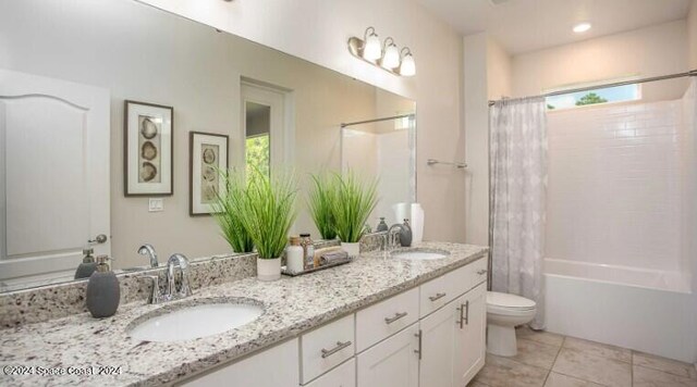 full bathroom featuring tile patterned flooring, shower / tub combo, vanity, and toilet