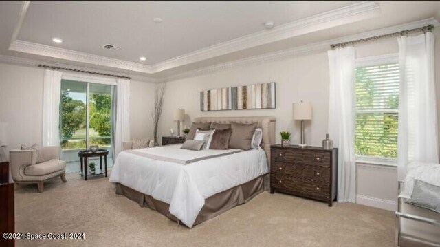 carpeted bedroom with a raised ceiling, multiple windows, and ornamental molding