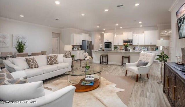 living room featuring crown molding and light hardwood / wood-style floors