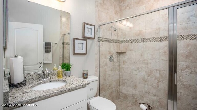 bathroom with vanity, toilet, and an enclosed shower