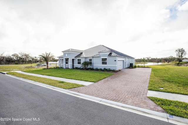 view of front of property with a garage and a front yard