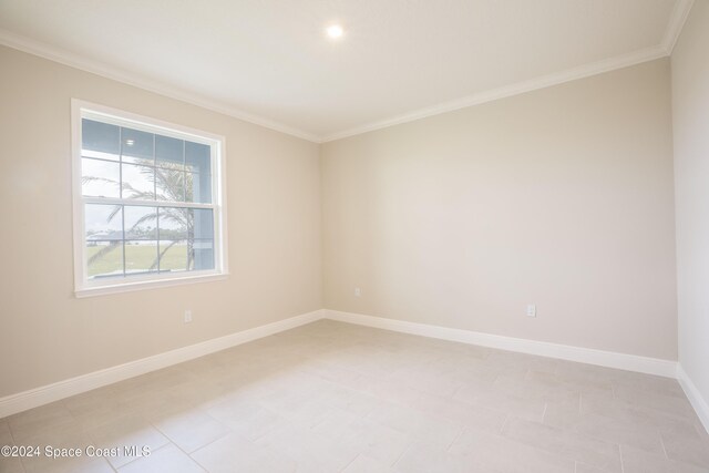 unfurnished room with crown molding and light tile patterned flooring