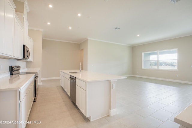 kitchen with white cabinets, appliances with stainless steel finishes, and a kitchen island with sink