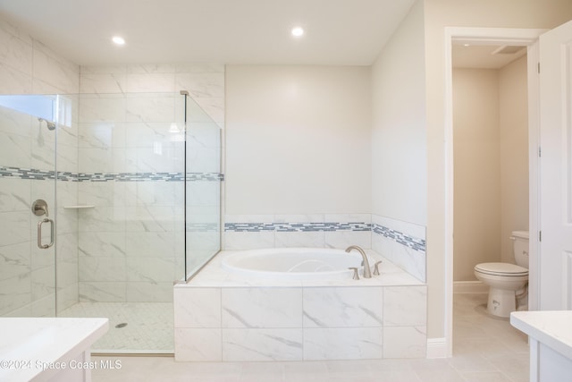 full bathroom featuring vanity, toilet, tile patterned flooring, and shower with separate bathtub