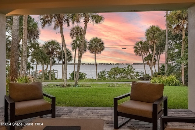 surrounding community featuring a yard and a water view