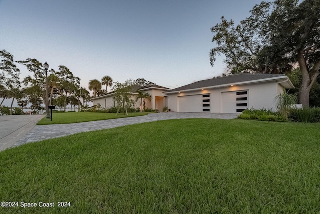 view of front of property featuring a garage and a front lawn