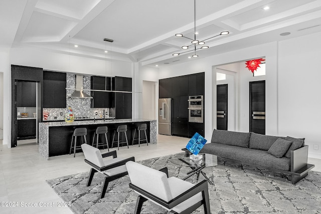 living room with sink, light tile patterned floors, a towering ceiling, and coffered ceiling