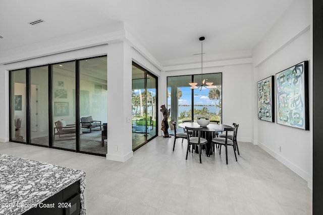 tiled dining area featuring a chandelier