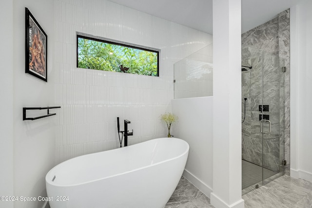 bathroom featuring tile walls, independent shower and bath, and tile patterned floors