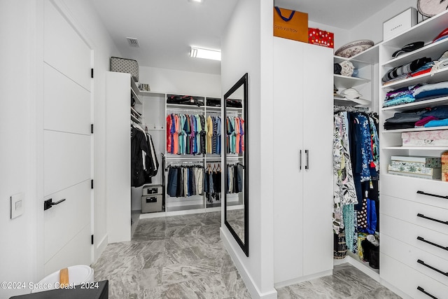 spacious closet with light tile patterned floors