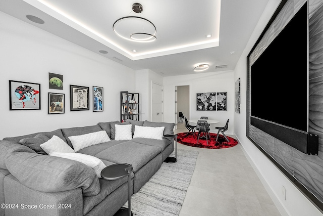 living room featuring a tray ceiling