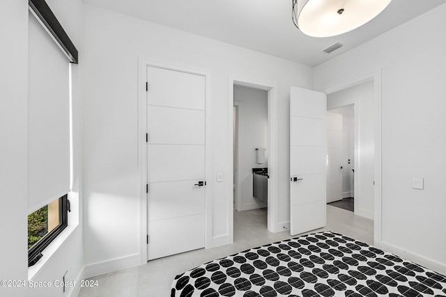 unfurnished bedroom featuring a closet and ensuite bathroom