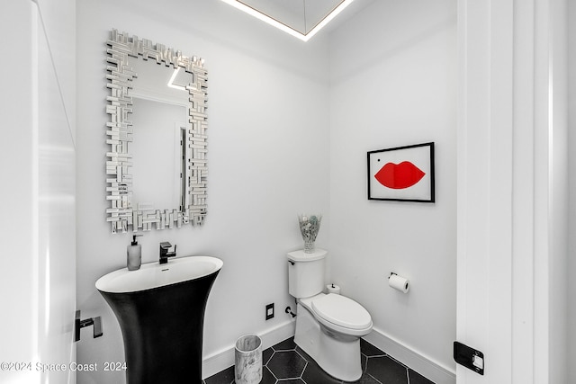 bathroom featuring tile patterned floors, sink, and toilet