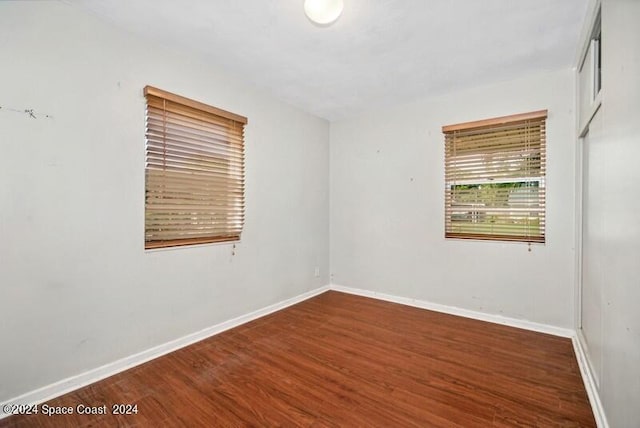 empty room with dark wood-type flooring